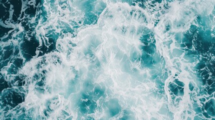 Fototapeta premium A powerful wave sweeps toward the shore, colliding with the water to create vibrant foam in the striking blue ocean