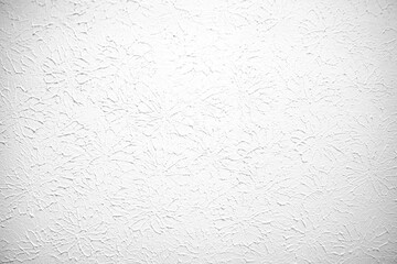 White textured wall or ceiling with plaster painted. Flat light texture with circular pattern and artistic impression.