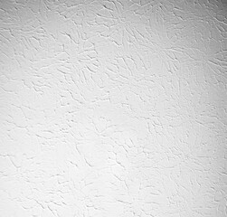 White textured wall or ceiling with plaster painted. Flat light texture with circular pattern and artistic impression.
