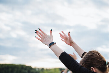 A Joyful Celebration with Hands Raised High Against a Beautiful Blue Sky Brimming with Opportunities
