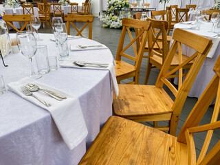 The tables and chairs are elegantly arranged for the wedding reception