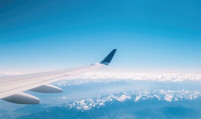 Fototapeta premium Airplane Wing and Snowy Mountain Range Viewed From Above