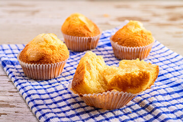 Halved Muffin with More in the Backgroundon a Kitchen Towel