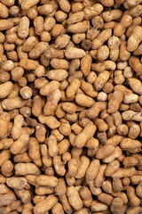 top view raw peanuts as background and texture at vertical composition