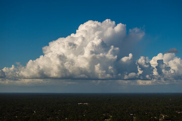 Florida weather. Blue sky with white summer rain clouds. Colorful summer landscape