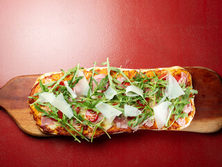 Arugula Jamon Pizza on a Cutting Board