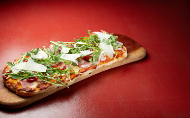 Arugula Jamon Pizza on a Cutting Board