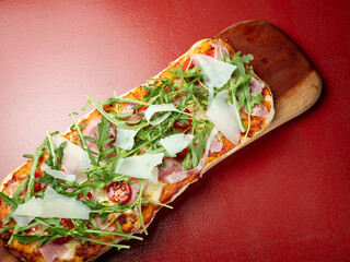 Arugula Jamon Pizza on a Cutting Board	