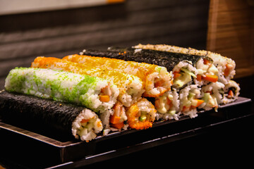 Sushi set or seaweed rice rolls on tray table background