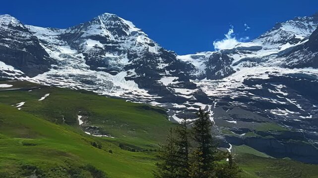 Mount Eiger North Mountain Peaks, Swiss Alps In Switzerland. Panning Shot