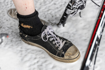 A person's foot is shown with a sock and a shoe
