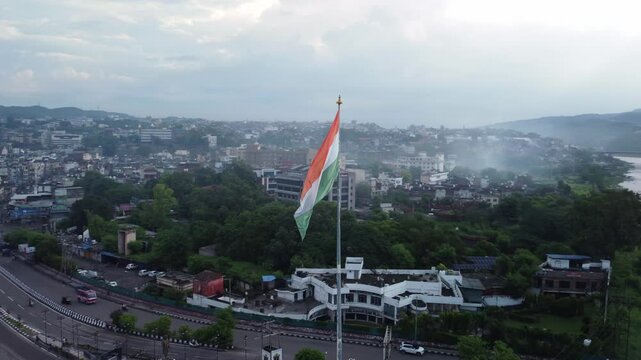 The National flag of India waving in Jammu city on the banks of Tawi river, Drone shot