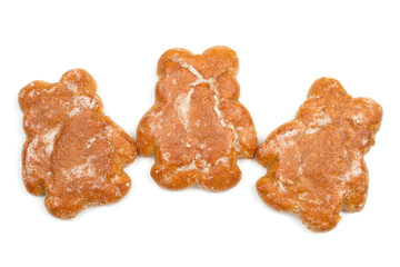 Three gingerbread in the shape of bear cubs on a white background. Sweet cookies.
