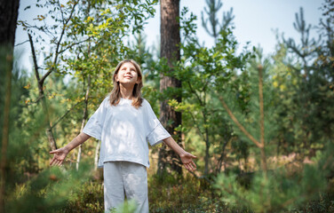 A teenage girl who breathes fresh air and relieves stress in the forest.