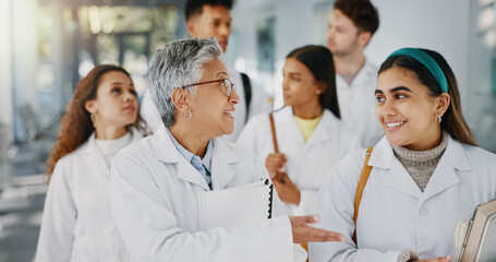 Healthcare, doctor and students walking in hospital with medical discussion, collaboration and...