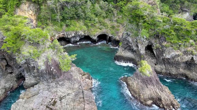 Top-Down View of Waves Breaking Against Rocky Shores