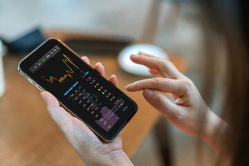 Hand hold smartphone with stock market chart financial trading, online investment, stock exchange...