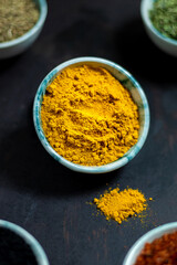 Traditional oriental spices in ceramic bowls. black cumin seed, ground red pepper, dried mint, himalayan ​​salt.