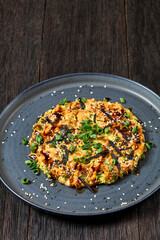 Japanese pancake with cabbage on a plate, top view