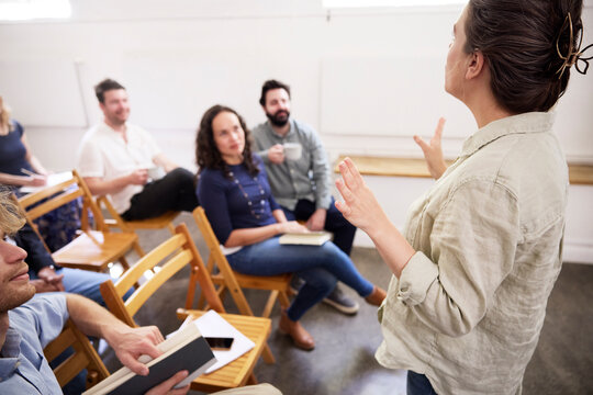 Businesswoman giving presentation to coworkers at office