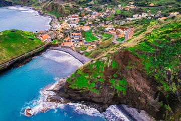 Aerial view of rough ocean with waves, volcanic beach in Porto da Cruz, Madeira, Portugal