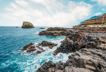 Madeira island nature scenery. View of Porto da Cruz village mountains landscape and ocean pool.