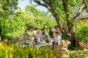 Friends with children having garden party