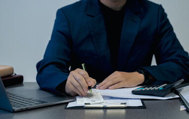 Man sitting with bills and taxes in office. Financial research. data analysis, documents, reports, tax returns, calculations.