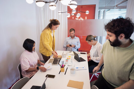 Group of multiracial coworkers working in illuminated office