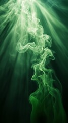 Fototapeta premium Abstract green smoke swirling on dark background