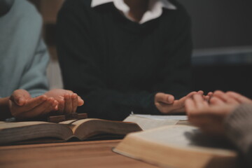 Christian group are praying to god with the bible and sharing the gospel. Concept of faith for god.