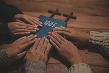 Christian group are praying to god with the bible and sharing the gospel. Concept of faith for god.