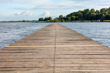 Wooden bridge on the lake in summer