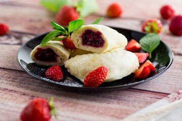 cooked sweet homemade steamed dumplings with strawberries
