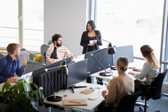 High angle view of male and female entrepreneurs working together at office