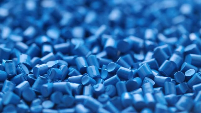 Close-up of blue colour masterbatch. Pigments for plastic injection moulding. Rotating view 