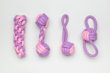 Colorful Handmade Purple and Pink Knotted Dog Toys on White Background