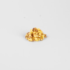 Close-up of a small pile of chopped nuts on a white background. Perfect for recipes, food blogs, and culinary presentations.