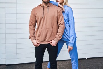 Fashionable pair in hoodies and pants