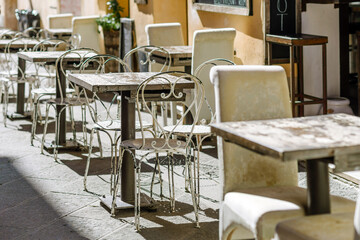 San Quirico D'Orcia, Siena Italy - August 25, 2024: tables and chairs of a bar in a street of the...