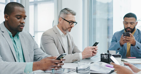 Smartphone, typing and distracted business people in office checking email, social media or online chat. Communication, connectivity and careless team in conference room with phone, addiction or risk