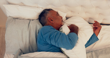 Sleeping, relax and senior man on bed for comfort with duvet, mattress and pillow in home. Rest, calm and elderly male person in retirement with afternoon nap in bedroom on weekend in house.