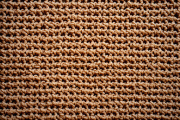 Closeup of cozy beige knit texture, representing warmth, fashion, and handmade craftsmanship