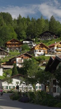 Vertical View Of Mountain Village Traditional Wooden Houses With Balcony In Upper Bavaria, Germany.