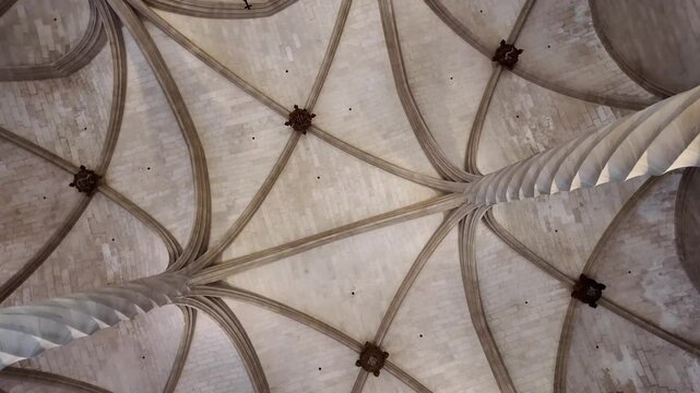 Spinning view of the roof of the Lonja of Palma de Mallorca from the floor, with helicoidal columns in white sandstone. 4K 60FPS
