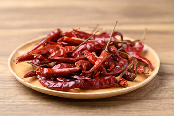 Dried red chili on wooden plate, Food ingredient