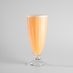Delicious peach smoothie in a tall glass on a plain background. Perfect for a refreshing summer drink concept.