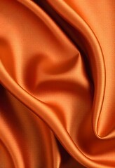 Abstract background luxury cloth or liquid wave smooth, flowing orange silk fabric with soft folds and highlights.
