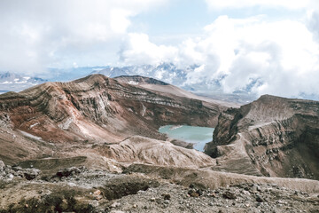 View of mountains and volcanoes from the edge of the crater