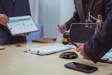 Three lawyers in a meeting at the table in an office, discussing business, civil and commercial law, labor law, marketing and advertising law,offering legal consulting and case management services.